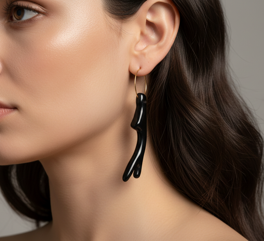 Cose E Bijoux Levanzo earrings featuring a gold 925 silver hoop and a black resin coral branch charm on a model