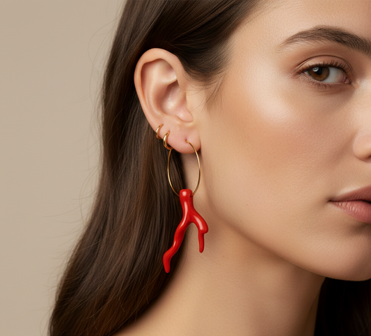 Cose E Bijoux Amalfi gold hoop earring with a red resin faux coral branch charm worn on a model