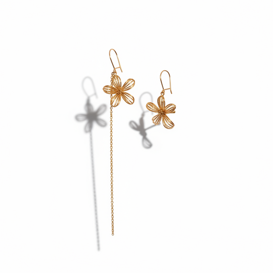 Cose E Bijoux Loulou gold wire flower earrings with a delicate dangling chain feature on one side